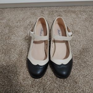 Black and cream oxford shoes with brogues.